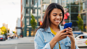 A woman is looking at her mobile phone.